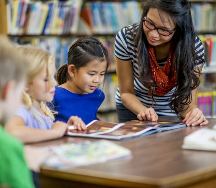 Librarian engaging with children in a library