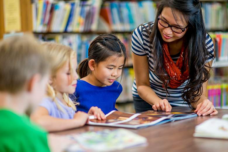 Librarian engaging with children in a library